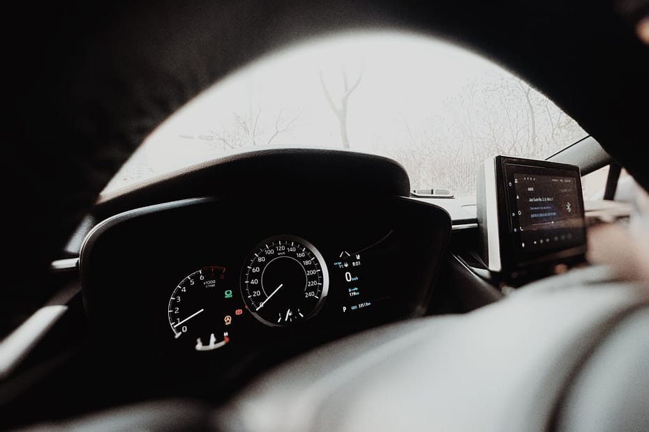 Interior view of a modern car dashboard with digital display and speedometer, captured in Tianjin, China.